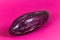 Eggplant, Shiny purple pink aubergine against pink background