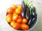 Eggplant and tomatoes in a pink basket