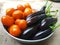 Eggplant and tomatoes in a pink basket