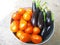 Eggplant and tomatoes in a pink basket