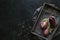 Eggplant varieties in black bowl over dark slate background