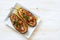 Eggplants stuffed with bulgur and vegetables on a white wooden background