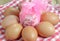 The eggs around gift and cloth on the wood background.