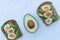 Eggs and avocado on toast on white marble background flat lay