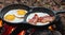 eggs with bacon cooking with oil with firewood in an outdoor camping in high resolution