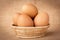 Eggs in a basket on gunny sackcloth background