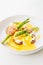 Eggs benedict with bacon twist asparagus