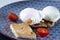 Eggs Benedict with meat steak, tomatoes and toast lying on a blue plate