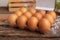 eggs of chicken in a plastic box placed on a wooden table