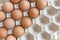 Eggs in egg box on wooden background top view / Close up of raw chicken eggs organic food