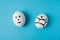 Eggs with faces, with the emotion of indifference and a masked face. Isolate on a blue background. The concept of people`s