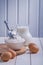 Eggs flour in transparent bowl pitcher with milk