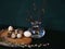 eggs glass vase branch buds wood table green background easter spring close-up