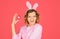 Eggs hunt. Smiling girl in rabbit ears with Easter egg. Woman in bunny ears with pink Easter egg. Easter rabbit girl