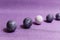 Eggs with marble stone effect painted with natural dye carcade flower on lilac sparkling background