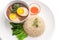 Eggs and pork in brown sauce served with brown rice, vegetable and chili sauce