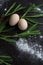 Eggs and Ramson on a black table, wood garlic and flour