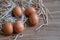 Eggs in a straw and one was written in a smiley face, laid on a wooden table