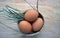 Eggs with straw in the wicker,wooden background