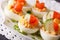 Eggs stuffed with salmon, cheese and cucumber closeup. horizontal