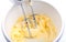 Eggs, sugar and butter cream in the mixing bowl process of homem