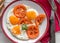 Eggs with tomatoes served, topview