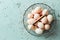 Eggs in a vintage metal mesh basket on pastel blue stone background