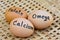 Eggs with word calcium,folate,omega on for food concept