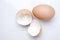 Eggshell and hen& x27;s egg on a light white marble background in the studio