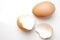 Eggshell and hen& x27;s egg on a light white marble background in the studio