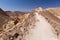 Egypt Israel boundary fencing in stone desert mountains trail.