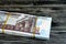 Egypt money stack of pounds  on wood background, pile of 50 EGP LE fifty Egyptian pounds cash money bills with a image of