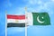 Egypt and Pakistan two flags on flagpoles and blue cloudy sky