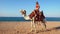 Egypt tourism with camel riding back for blond girl