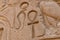 Egyptian ancient hieroglyphs on the stone wall. Closeup of the symbol of eternal life ankh