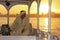 Egyptian captain driving his boat on the Nile river at sunset, L