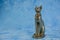 Egyptian cat Bast or Bastet, solar and war goddess, isolated on blue