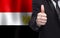 Egyptian concept. Businessman showing thumb up on the background of flag of Egypt