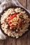Egyptian Cuisine: kushari close-up on the plate. Vertical top vi