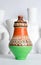 Egyptian decorated colorful pottery vase on background of white vases