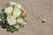 Egyptian desert agama lizard in desert with wedding flower bouquet
