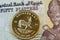 Egyptian fifty piastres bank note with a gold krugerrand note in macro