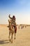 Egyptian guide offering to tourists camel ride