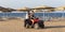 An Egyptian guide and a young girl ride on the beach near the red sea. Tours of the desert on Quad bikes.