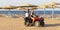 An Egyptian guide and a young girl ride on the beach near the red sea. Tours of the desert on Quad bikes.