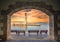 The Egyptian lighthouse at the old harbor of Rethimno through a frame of an arched door, Crete.