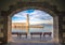 The Egyptian lighthouse at the old harbor of Rethimno through a frame of an arched door, Crete.