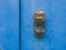 Egyptian metal door knocker on an old blue door