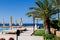 Egyptian resort yard with short palm trees with a dark blue clean bay water panorama on the Red Sea