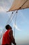 Egyptian sailor operating a traditional felucca sail